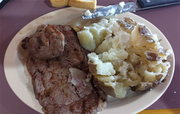 Smoked brisket with baked potato at Greg's BBQ in Belen